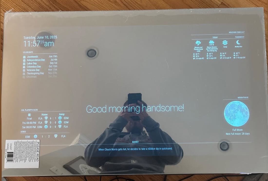 Smart mirror showing the time, weather, hockey scores, moon phase, and a Chuck Norris fact