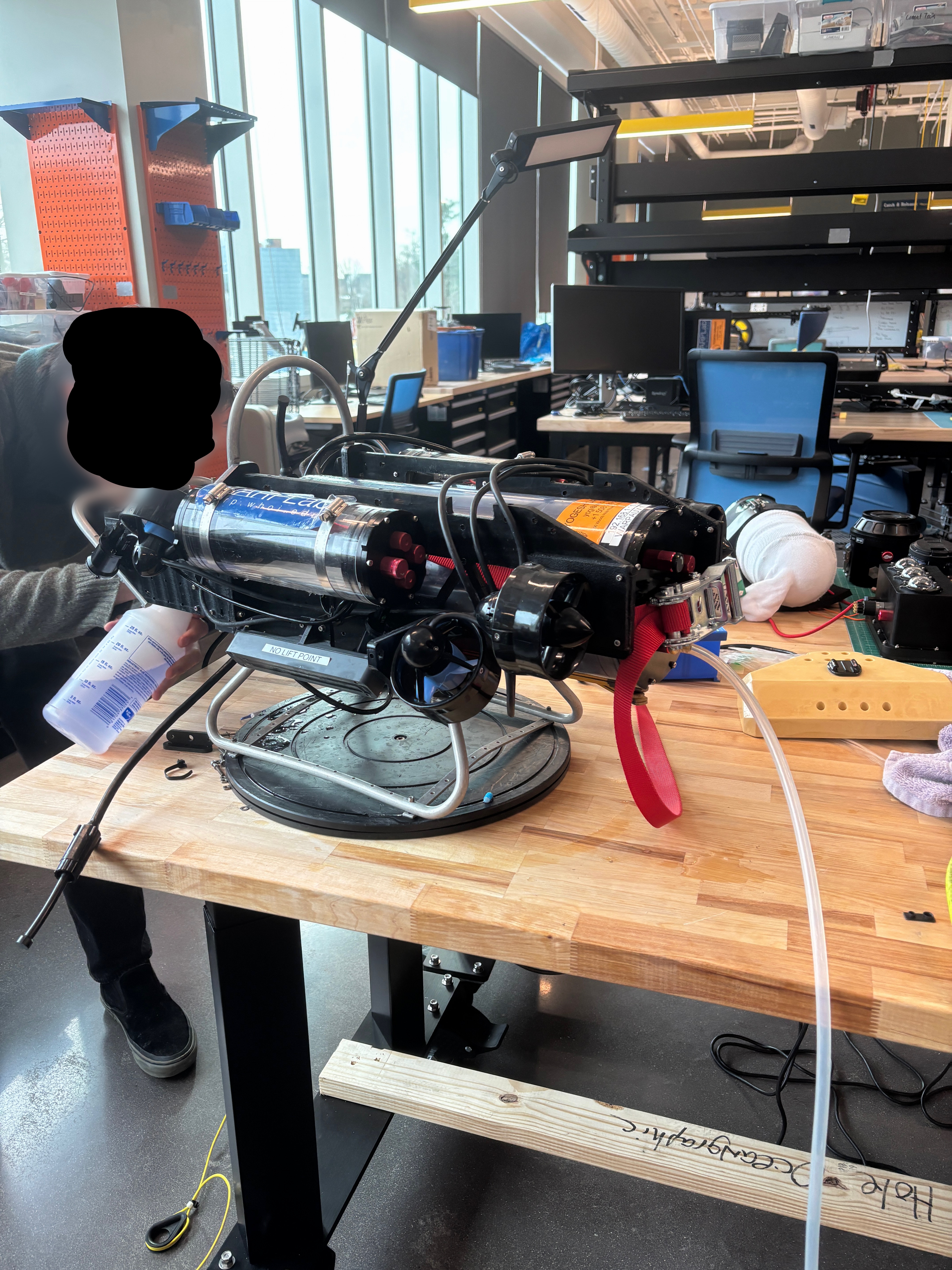 Spraying soapy water on penetrators to find leaks.